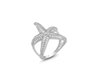 May include: A silver ring with a clear crystal starfish design.