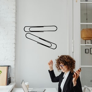 Paper clip wall decal featuring oversized office stationery line art, minimalist workspace decor with modern design, subtle nod to Paperclip Project history and classroom symbolism. Paper clips wall or window decal. Unique office or school supplies wall art. Set of 2 paperclips.