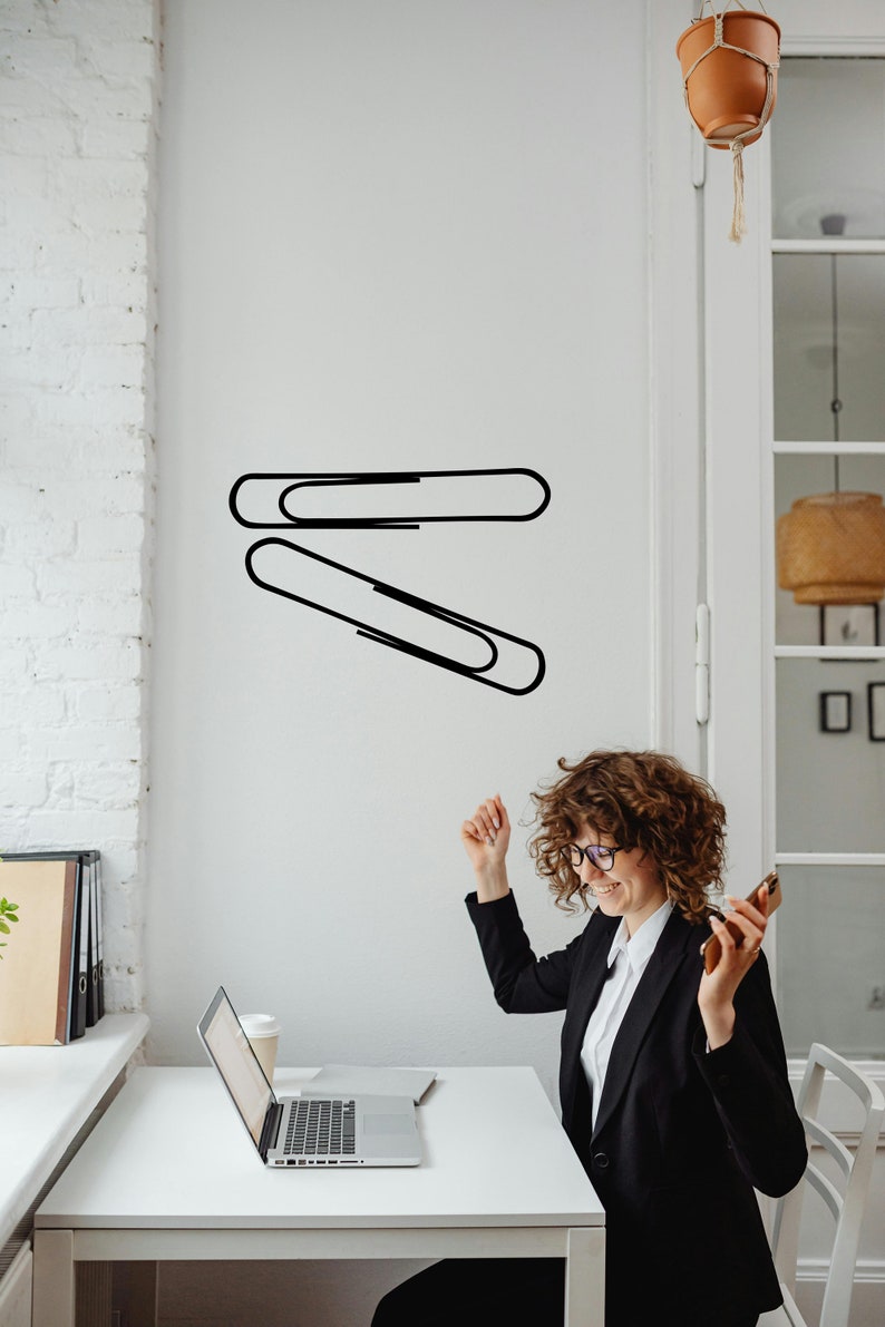 Paper clip wall decal featuring oversized office stationery line art, minimalist workspace decor with modern design, subtle nod to Paperclip Project history and classroom symbolism. Paper clips wall or window decal. Unique office or school supplies wall art. Set of 2 paperclips.