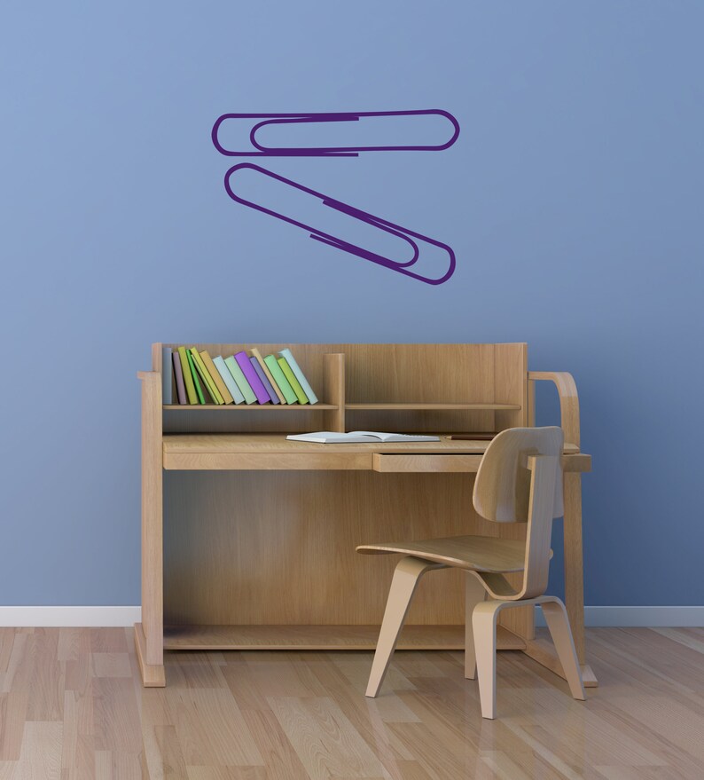 Minimalist paper clip decal inspired by office stationery art, contemporary wall decor for teacher classroom, study area, and subtle Operation Paperclip conversation piece.