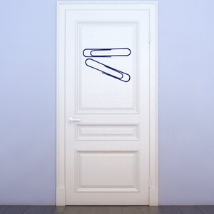 Paper clip wall art design in sleek minimalist style, office decor graphic suited for teacher gifts, study room inspiration, and symbolic remembrance themes.