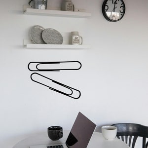 Paper clip decor wall art in simple outline style, study room graphic for teacher classroom, modern corporate workspace, and subtle WWII history theme.