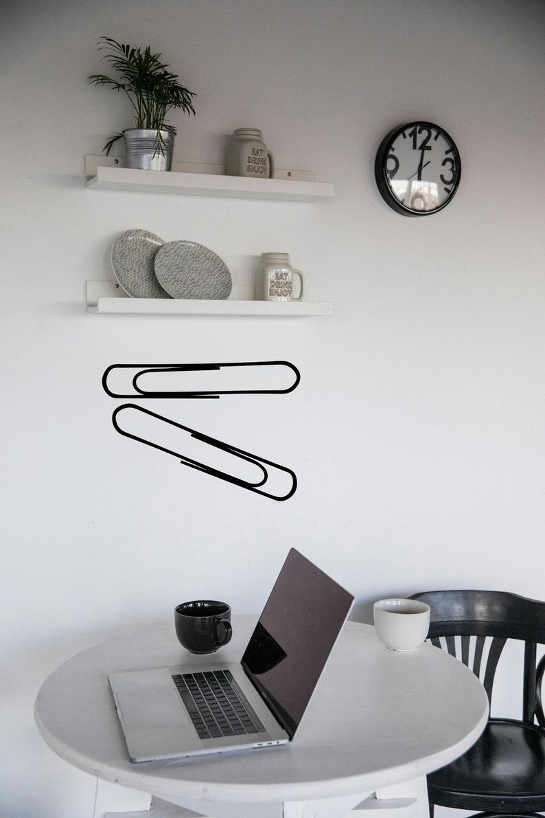 Paper clip decor wall art in simple outline style, study room graphic for teacher classroom, modern corporate workspace, and subtle WWII history theme.
