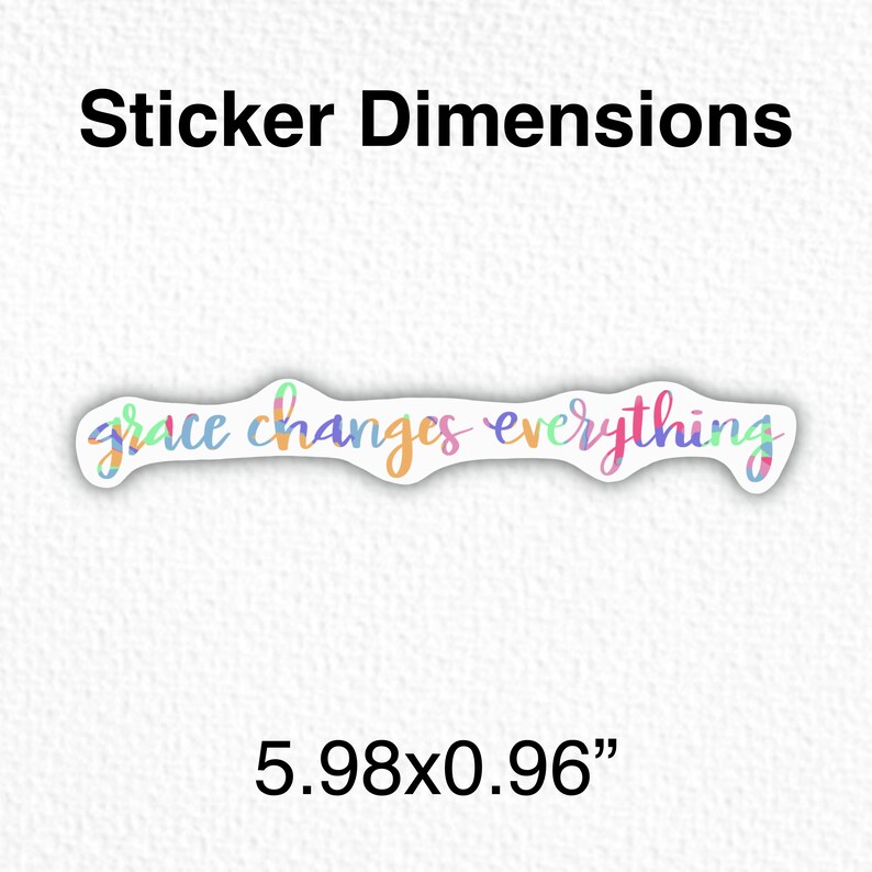 May include: A colorful sticker with the text "grace changes everything" in a handwritten font. The sticker is 5.98 inches by 0.96 inches.