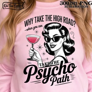 Puede incluir: Sudadera rosa claro con un diseño gráfico de una mujer con gafas de sol y un cóctel. El texto dice: "WHY TAKE THE HIGH ROAD? -when you can TAKE THE Psycho Path". Incluye las palabras "300 DPI PNG SUBLIMATION".