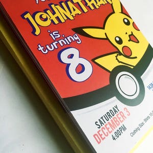 May include: A red and yellow birthday invitation with a cartoon Pikachu character. The invitation says "You are invited! Johnathan is turning 8. Saturday December 3 4:00PM".
