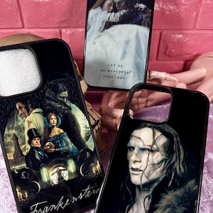 May include: Three black phone cases with horror-themed graphics. One case features a scene from Frankenstein with the title. Another shows a couple embracing with the text "Let us be monsters together." The third case displays a monster.