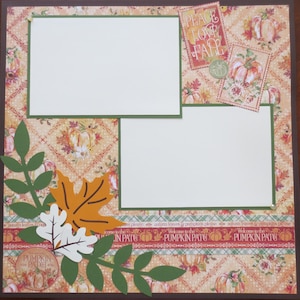 May include: A scrapbook page with a fall theme. It features two white photo mats, decorative paper with pumpkins and leaves, and embellishments including paper leaves and the text "PEACE LOVE FALL". The bottom border reads "PUMPKIN PATCH".
