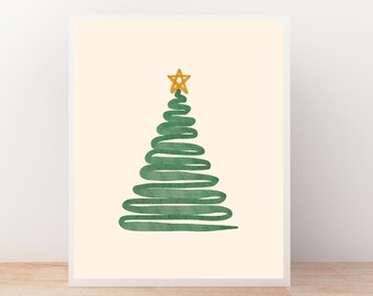 May include: A framed print featuring a minimalist Christmas tree design. The tree is rendered in green watercolor strokes, topped with a gold star, set against a cream background. The artwork is displayed in a white frame.