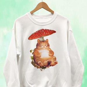 Chubby Cat Resting on Mushroom Sweatshirt Unisex