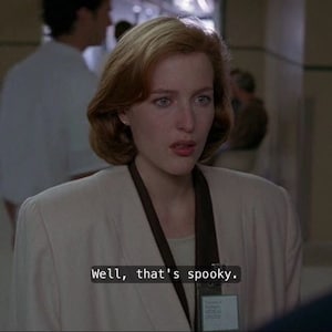 May include: A woman with short, reddish-brown hair wearing a white blazer and a brown lanyard with a name tag that reads "University of Maryland Medical Center". She is looking at the camera and saying, "Well, that's spooky."