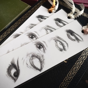 May include: A set of three ceramic mugs with a speckled, matte finish. The mugs are in shades of cream, light gray, and dark gray. Each mug has a simple, minimalist design, perfect for coffee or tea.