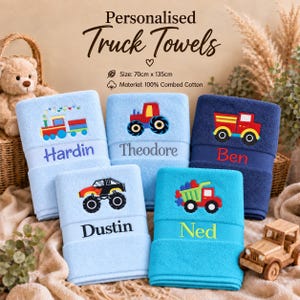 May include: Five personalised cotton towels measuring 70cm x 135cm, each featuring embroidered truck designs and names. The towels are in shades of blue and navy, displaying colourful train, tractor, dump truck, and monster truck graphics.