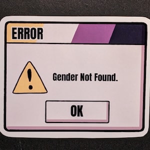 May include: A white error message box with a yellow exclamation point triangle and the text "Gender Not Found."  The box has a purple and black bar at the top and a white button that says "OK".