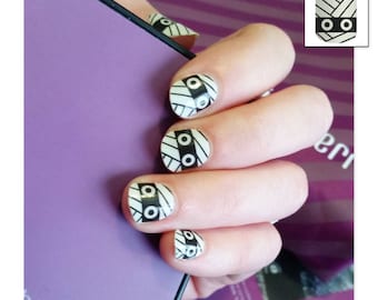 May include: Black and white nail wraps with a geometric pattern. The wraps are applied to a person's fingernails. The text "All Wrapped Up" is below the image.