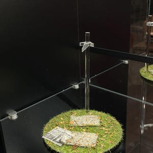 May include: A white ceramic mug with a black handle and the text "But First, Coffee" in a handwritten style. The mug is on a white surface. The mug is approximately 4 inches tall.