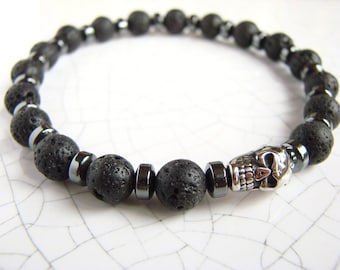 May include: Black lava rock and hematite bead bracelet with a silver skull charm.