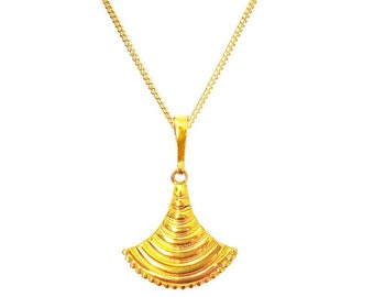 May include: A gold-colored necklace featuring a thin chain and a fan-shaped pendant. The pendant has a series of horizontal, curved ridges that create a layered, textured appearance, tapering to a point at the top where it connects to the chain.