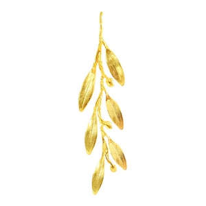 May include: A gold-colored olive branch pendant with delicate leaves and small berries. The pendant is a simple and elegant design.