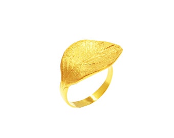 Puede incluir: Un anillo de hoja de oro con una superficie texturizada.