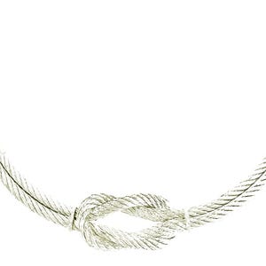 May include: A silver necklace with a knotted design. The necklace is made of a braided cable chain.