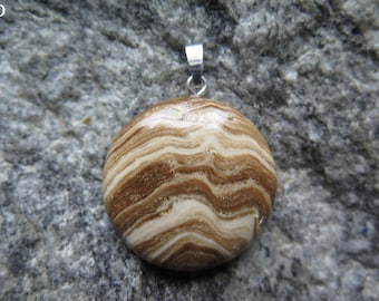 May include: A round, brown and white agate pendant with a silver bail. The agate has a swirling pattern of brown and white stripes.