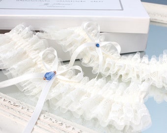 Conjunto de liga de boda de encaje marfil con algo azul, ligas de novia