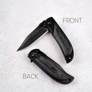 a knife and a pocket knife on a white surface