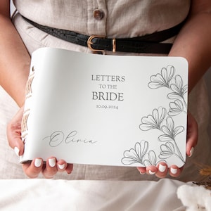 May include: White leather-bound journal with the text "Letters to the Bride" and the date "10.09.2024". The journal has a floral design and the name "Olivia" is written in cursive.