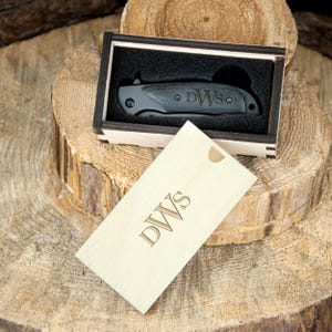 a wooden box with a knife inside of it