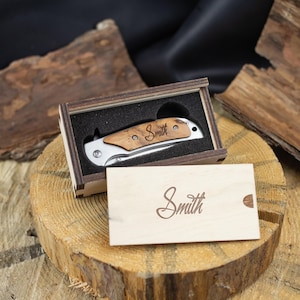 a wooden box with a knife inside of it