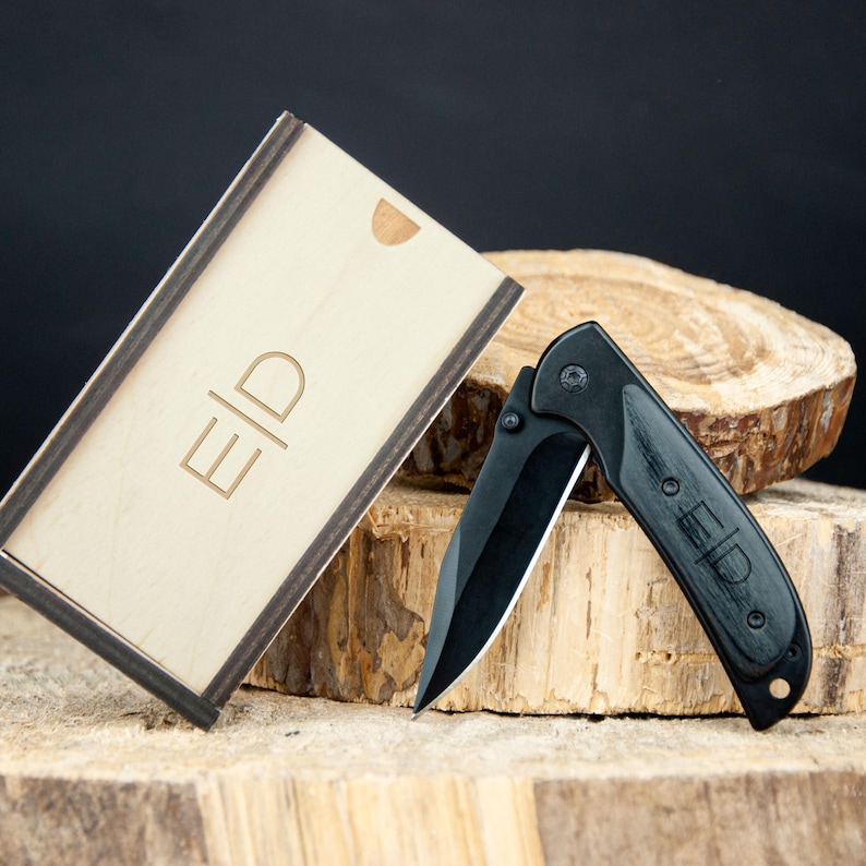 a knife sitting on top of a piece of wood