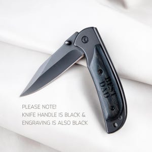 a knife that is laying on a white sheet
