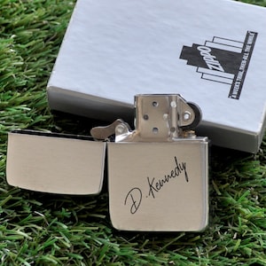 May include: Silver Zippo lighter with a personalized inscription that reads "D. Kennedy".