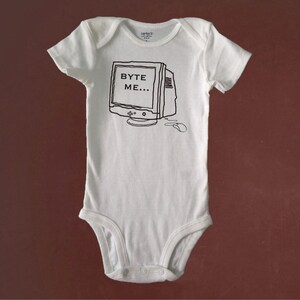 May include: White baby onesie with a black and white illustration of a computer monitor with the text "BYTE ME..." on the screen.