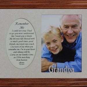 May include: A framed photo with a poem about remembering a loved one. The poem is in an oval shape and the photo is of an older man and a younger boy. The photo is captioned "Grandpa".