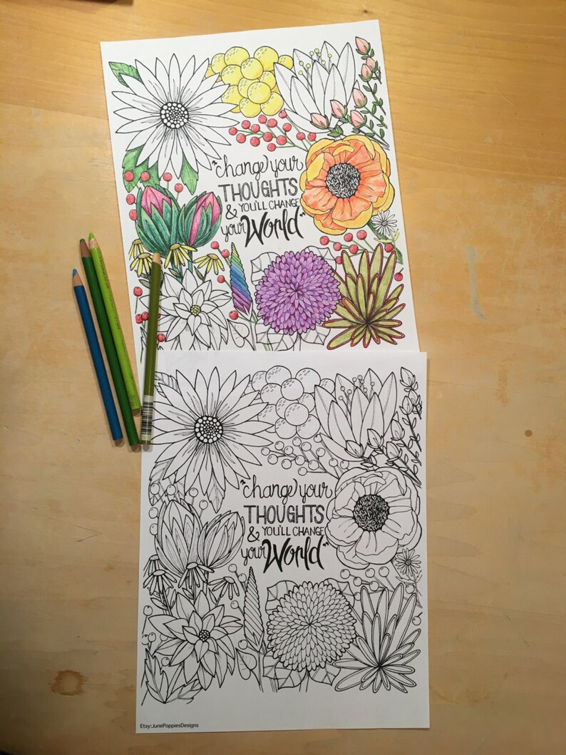 May include: Two floral coloring pages with the text "change your thoughts & you'll change your world." One page is colored with various hues, and the other is uncolored. Several colored pencils in shades of blue and green are on the left.