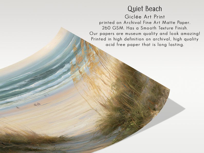 May include: A Gicl&eacute;e art print titled Quiet Beach on archival fine art matte paper with a 260 GSM smooth texture finish. The print features a coastal scene with golden beach grass in the foreground, a sandy shore, and blue ocean waves.