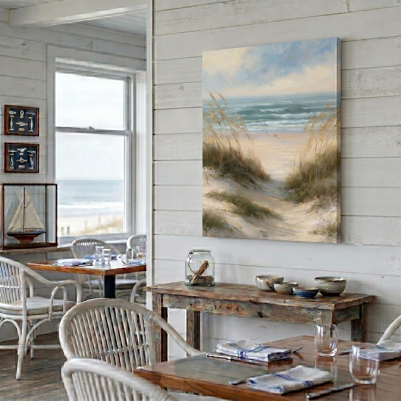 May include: A rectangular canvas wall art print featuring a coastal landscape with tall beach grass in the foreground, a sandy path leading toward the ocean, and a soft blue sky with light clouds above the horizon line of the sea.