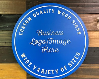 May include: A round, blue wooden sign with white text that reads "Custom Quality Wood Signs" and "Wide Variety of Sizes". The sign also has the text "Business Logo/Image Here" in white cursive font.