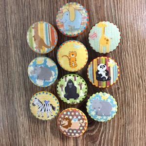 May include: Ten round, colorful, wooden knobs with different animal designs. Each knob features a different animal, including a giraffe, elephant, zebra, lion, panda, gorilla, and more. The knobs are perfect for adding a touch of whimsy to any room.
