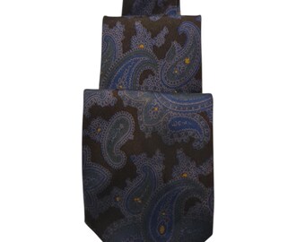 Pode incluir: Uma gravata castanha escura com um padrão paisley azul. A gravata é feita de um tecido liso e apresenta um design repetido de formas paisley azuis e amarelas. Um acessório clássico.