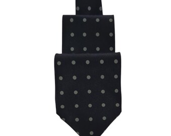 May include: A dark blue necktie with a white polka dot pattern.