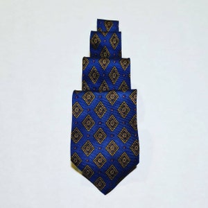 May include: A blue silk tie with a geometric pattern of gold and purple diamonds.