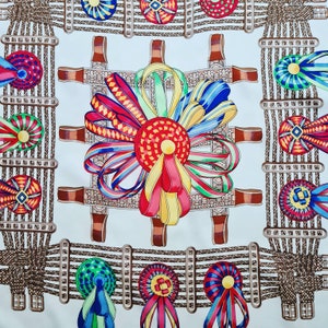 May include: A white fabric with a repeating pattern of brown rope, colorful rosettes, and ribbons. The rosettes are in shades of red, blue, green, and yellow. The ribbons are in shades of red, blue, green, and yellow.