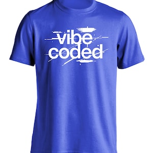 May include: A bright blue short-sleeved t-shirt featuring the white text "vibe coded" printed across the chest. The lettering has a distressed, glitch-like aesthetic with horizontal lines and fragmented edges integrated into the design.