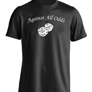 May include: A black t-shirt with the text "Against All Odds" in white lettering and a graphic of two white dice.