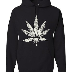 May include: Black hooded sweatshirt with a white marijuana leaf graphic.