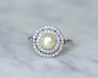 Old fine pearl ring and double diamond surround on platinum