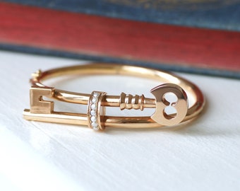 Old bangle bracelet, rose gold key and pearls